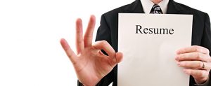 business man holding a resume with okay sign